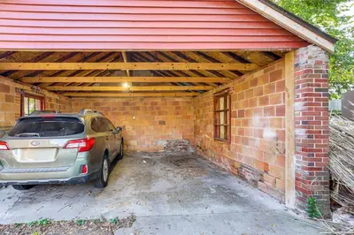 a car parked inside of a brick garage at Striking Tudor Revival in Five Points District! in Toledo