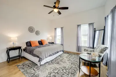 a bedroom with a bed and a ceiling fan at Walk to UC and Hospitals! Cincy Home with Patio in Cincinnati