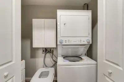 a washer and dryer in a small bathroom at Walk to Lagoon Saloon! Chic Home on Nugents Canal in Port Clinton