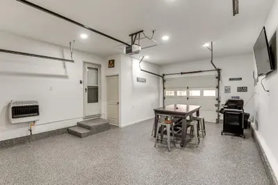 an empty room with a table and a garage at Walk to Lagoon Saloon! Chic Home on Nugents Canal in Port Clinton