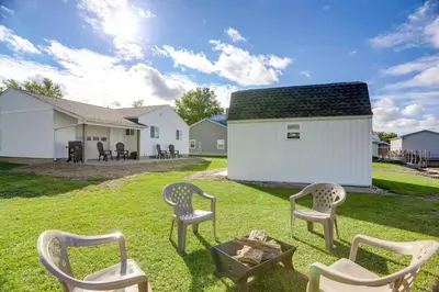 a group of chairs sitting around a fire pit at Walk to Lagoon Saloon! Chic Home on Nugents Canal in Port Clinton