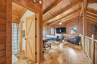 a log cabin with a living room and a dining room at Sprinkle Bottom Lodge- 12 Acre Cabin, Pond, AC, Heating & Pet Friendly