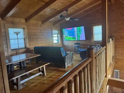 a living room with a couch and a table at Sprinkle Bottom Lodge- 12 Acre Cabin, Pond, AC, Heating & Pet Friendly