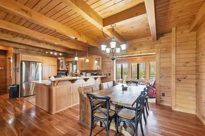 a dining room and kitchen with a table and chairs at Sprinkle Bottom Lodge- 12 Acre Cabin, Pond, AC, Heating & Pet Friendly
