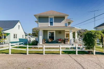 a house with a white fence in front of it at 10 Mi to Mad River Mtn Family-Friendly Retreat! in West Liberty
