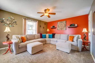 a living room with a couch and a ceiling fan at 10 Mi to Mad River Mtn Family-Friendly Retreat! in West Liberty
