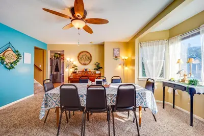 a dining room with a table and a ceiling fan at 10 Mi to Mad River Mtn Family-Friendly Retreat! in West Liberty