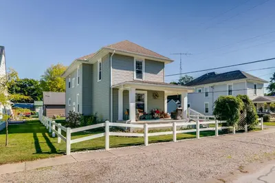 a house with a white fence in front of it at 10 Mi to Mad River Mtn Family-Friendly Retreat! in West Liberty