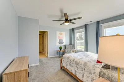 a bedroom with a bed and a ceiling fan at Private Yard and Pond Views Fort Wayne Family Home! in Fort Wayne