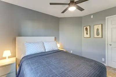 a bedroom with a bed and a ceiling fan at Private Yard and Pond Views Fort Wayne Family Home! in Fort Wayne