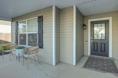 a porch with two chairs and a door at Private Yard and Pond Views Fort Wayne Family Home! in Fort Wayne