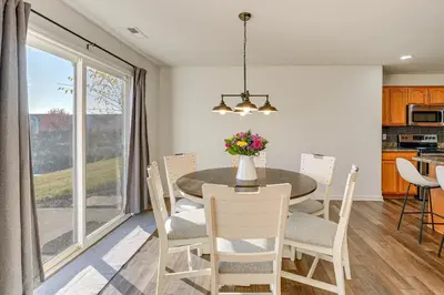 a kitchen and dining room with a table and chairs at Private Yard and Pond Views Fort Wayne Family Home! in Fort Wayne