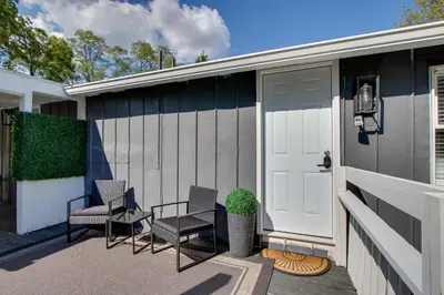 a house with two chairs and a door at Peaceful Country Apt Extended Stays Welcome! in Pataskala