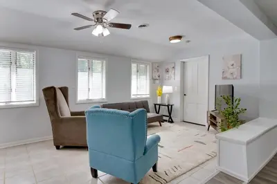 a living room with a blue chair and a couch at 21 Mi to Dtwn Columbus Quiet Country Escape in Pataskala