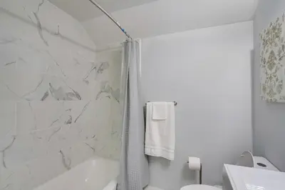a white bathroom with a tub and a sink at 21 Mi to Dtwn Columbus Quiet Country Escape in Pataskala