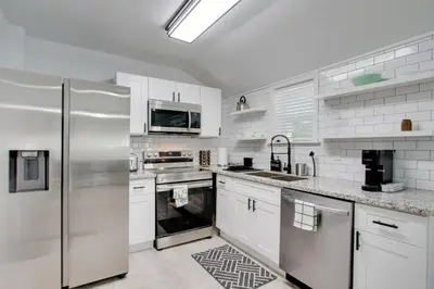 a kitchen with white cabinets and a stainless steel refrigerator at 21 Mi to Dtwn Columbus Quiet Country Escape in Pataskala
