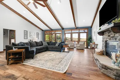 a living room with a couch and a fireplace at Calaboose Retreat in Campton