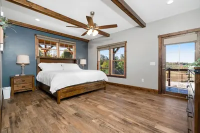 a bedroom with a bed and a ceiling fan at Calaboose Retreat in Campton