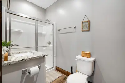 a bathroom with a toilet and a shower at Calaboose Retreat in Campton