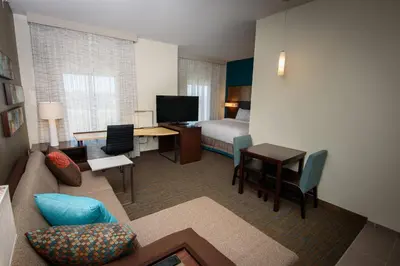 a hotel room with a couch and a bedroom at Residence Inn by Marriott Cleveland Avon at The Emerald Event Center in Avon