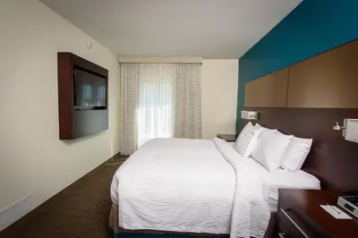 a hotel room with a large bed and a television at Residence Inn by Marriott Cleveland Avon at The Emerald Event Center in Avon