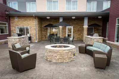 a patio with a fire pit and chairs and tables at Residence Inn by Marriott Cleveland Avon at The Emerald Event Center in Avon