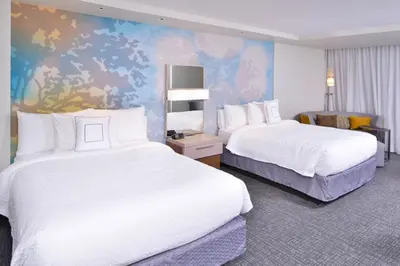 a hotel room with two beds and a mural at Courtyard by Marriott Columbus Grove City in Grove City