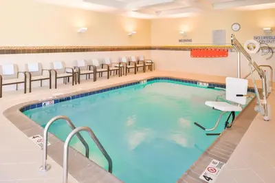 a pool in a waiting room with chairs at Courtyard by Marriott Columbus Grove City in Grove City
