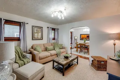 a living room with a couch and a table at 1 Mi to Akron Zoo Ranch-Style Home with Yard! in Akron