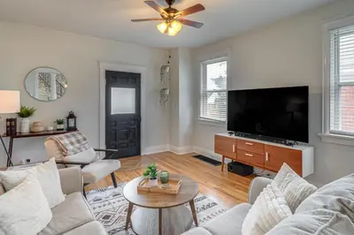a living room with a couch and a tv at Pet-Friendly Oakley Gem with Large Backyard! in Cincinnati