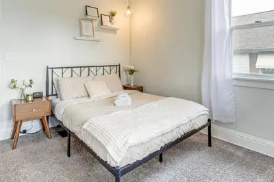 a bedroom with a bed and a nightstand and a window at Pet-Friendly Oakley Gem with Large Backyard! in Cincinnati