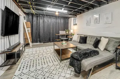 a living room with a couch and a tv at Pet-Friendly Oakley Gem with Large Backyard! in Cincinnati