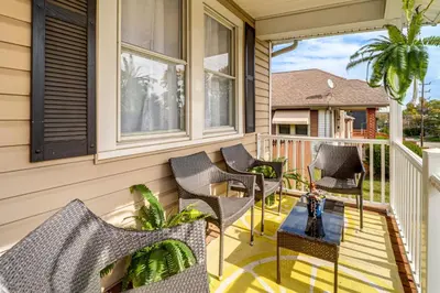 a porch with chairs and a table on a house at Pet-Friendly Oakley Gem with Large Backyard! in Cincinnati