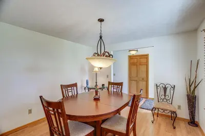 a dining room with a wooden table and chairs at Work and Relax! Spacious Ontario Home with Pool