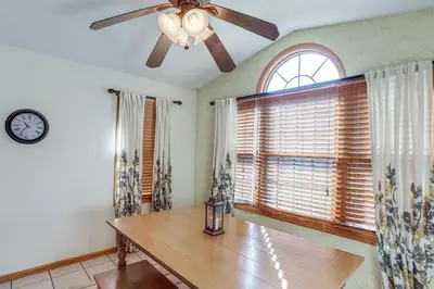 a dining room with a ceiling fan and a table at Work and Relax! Spacious Ontario Home with Pool