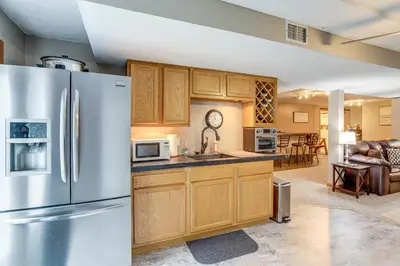 a kitchen with a stainless steel refrigerator at Work and Relax! Spacious Ontario Home with Pool