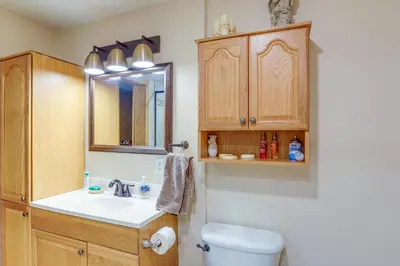 a bathroom with a sink and a toilet and a mirror at Work and Relax! Spacious Ontario Home with Pool