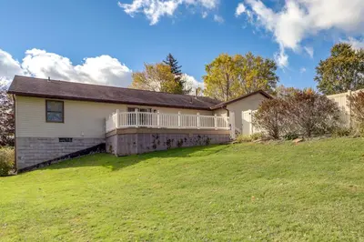 a house with a large yard in front of it at Work and Relax! Spacious Ontario Home with Pool
