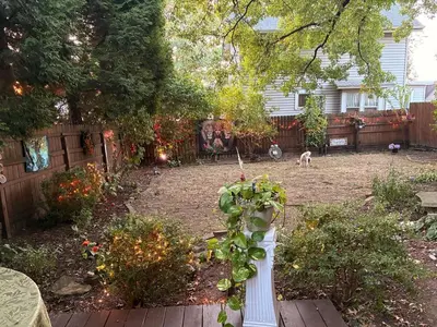 a garden with a white pole with a plant in it at Tree House 6 bedrooms, 2 blocks from everything in Cuyahoga Falls