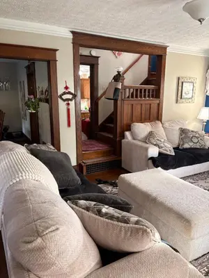 a living room with two couches and a staircase at Tree House 6 bedrooms, 2 blocks from everything in Cuyahoga Falls