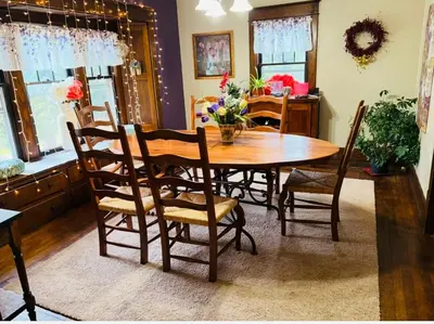 a dining room with a wooden table and chairs at Tree House 6 bedrooms, 2 blocks from everything in Cuyahoga Falls