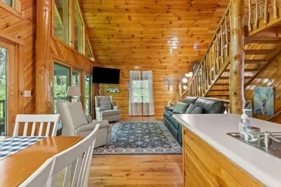 a kitchen and living room in a log cabin at Hot Tub & WiFi - Birdsong - Red River Gorge KY in Stanton