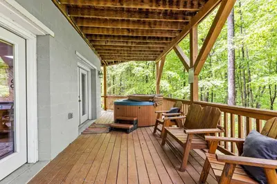 a porch with chairs and a grill on a house at Hot Tub & WiFi - Birdsong - Red River Gorge KY in Stanton
