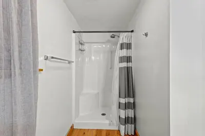 a bathroom with a shower with a shower curtain at Hot Tub & WiFi - Birdsong - Red River Gorge KY in Stanton