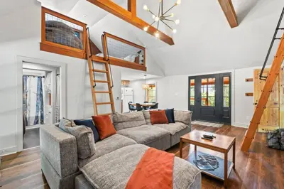 a living room with a couch and a loft at Hot Tub - Furnace Mountain Retreat - #RRG in Stanton