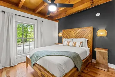 a bedroom with a large bed and a window at Hot Tub - Furnace Mountain Retreat - #RRG in Stanton