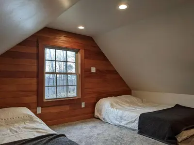 a attic bedroom with two beds and a window at Hot Tub - Furnace Mountain Retreat - #RRG in Stanton