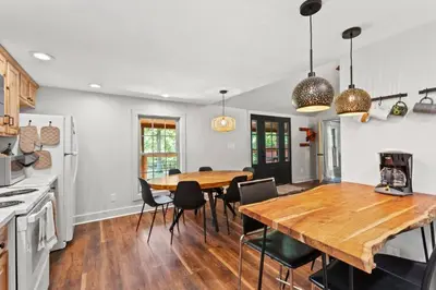 a kitchen and dining room with a wooden table and chairs at Hot Tub - Furnace Mountain Retreat - #RRG in Stanton