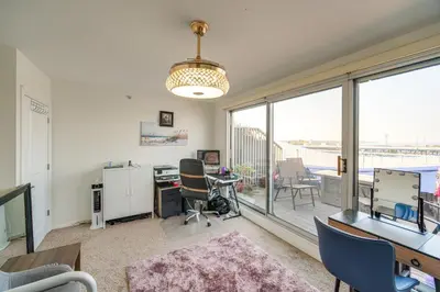 an office with a desk and chairs and a large window at 3 Mi to Dtwn Cleveland Condo with Lake Erie Views! in Cleveland
