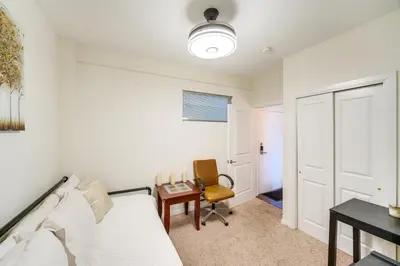 a room with a bed and a desk and a chair at 3 Mi to Dtwn Cleveland Condo with Lake Erie Views! in Cleveland